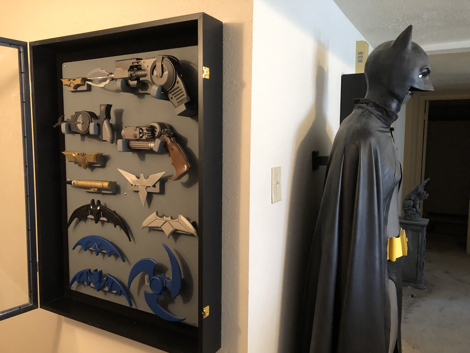 Ecclectic bat gadget display and comic suit.jpg