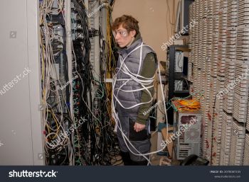 stock-photo-there-is-a-technician-wrapped-in-wires-in-the-server-room-a-lot-of-wires-are-in-th...jpg