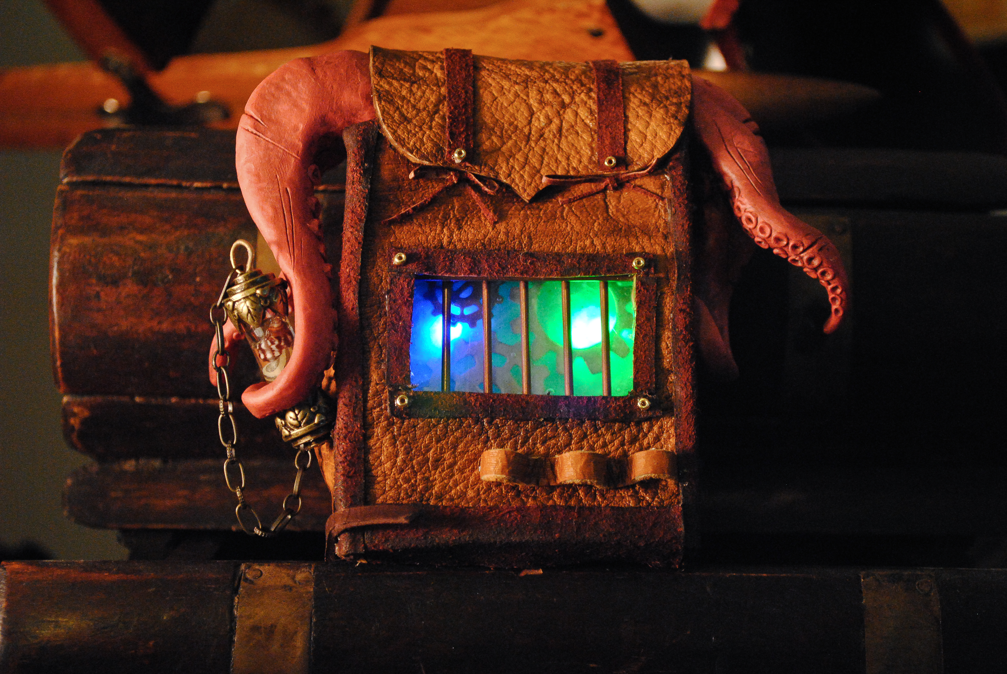 A doll-sized deer-skin "Traveler's Bag" made for a steampunk doll convention. Complete with inner LED lighting and sculpted tentacles.