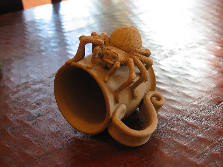 A little mug I made. Unfired clay.
It's going to be nice and creepy sipping my Joe with his little-bitty eyes staring at me!