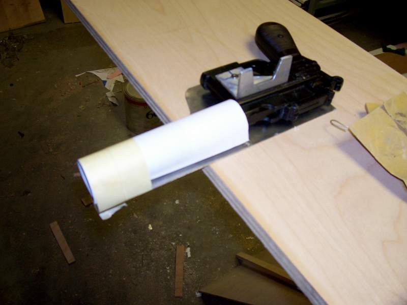 Aluminum rail mounted on the blaster, beginning to form the cardboard for the fiberglass holster. The fiberglass will later be wrapped in leather.