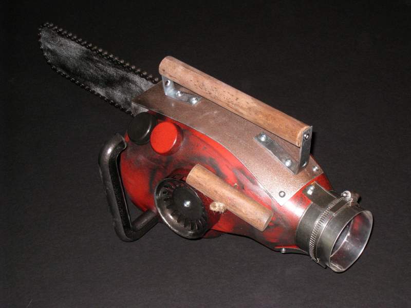 Chainsaw prop for my Ash costume, made from a laundry detergent container, cookie cutters, sink drain cover, toilet paper roll hanger, brackets, wood,