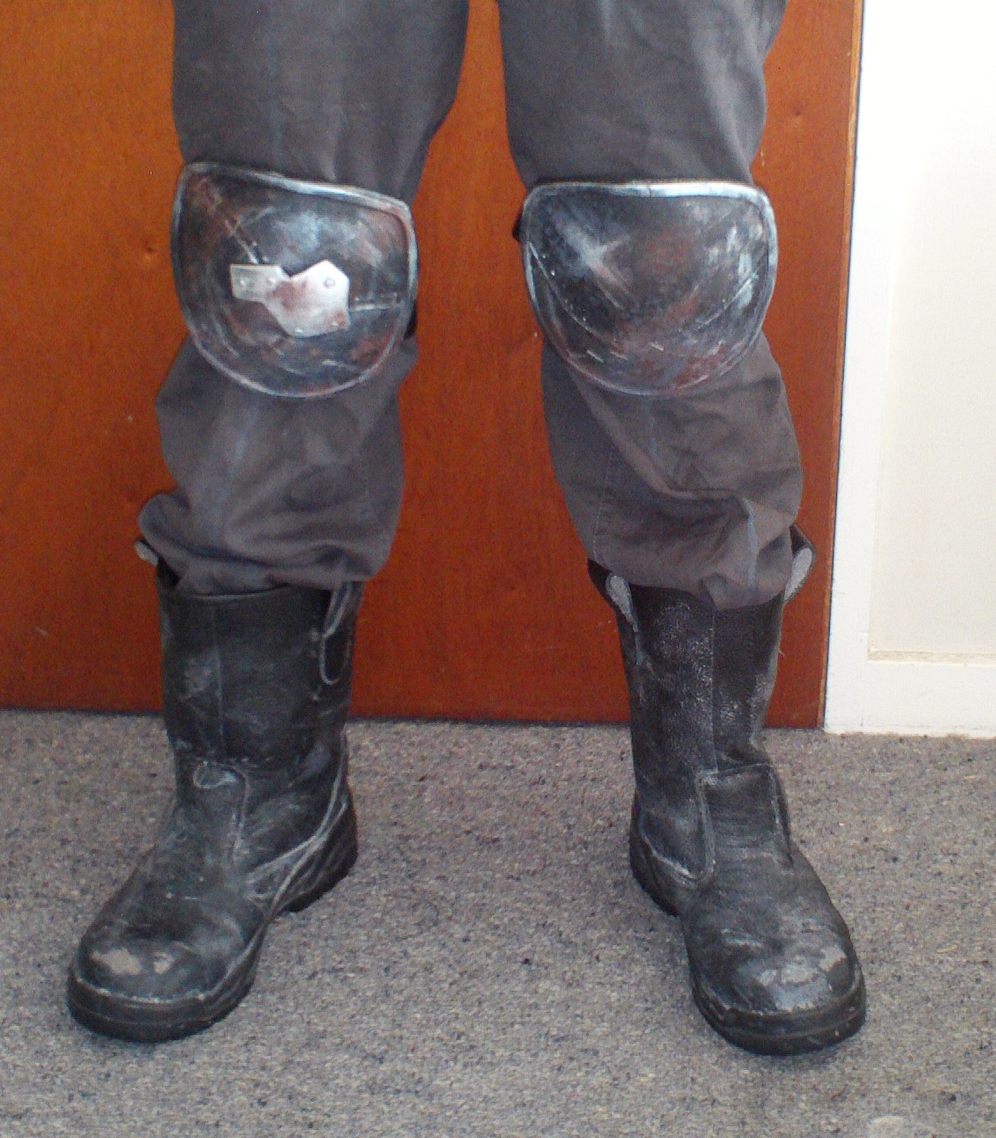 Craft foam kneepads and weathered steel-cap work boots.