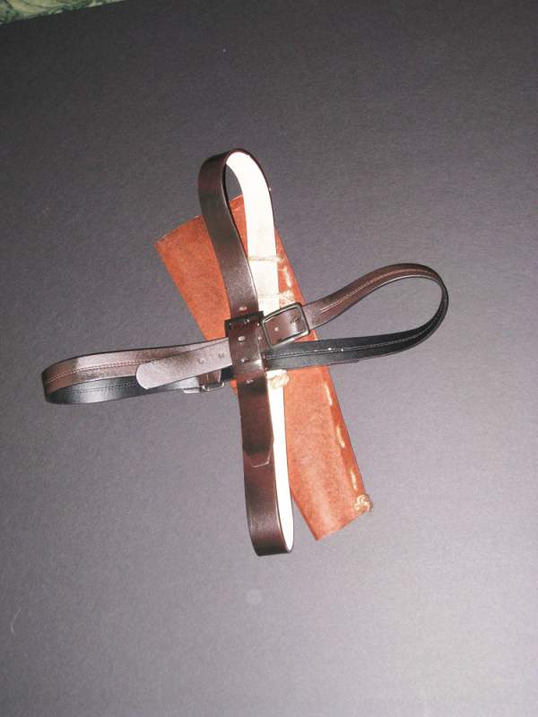 Harness prop for my Ash costume, made from belts and a portfolio cover which was stained.