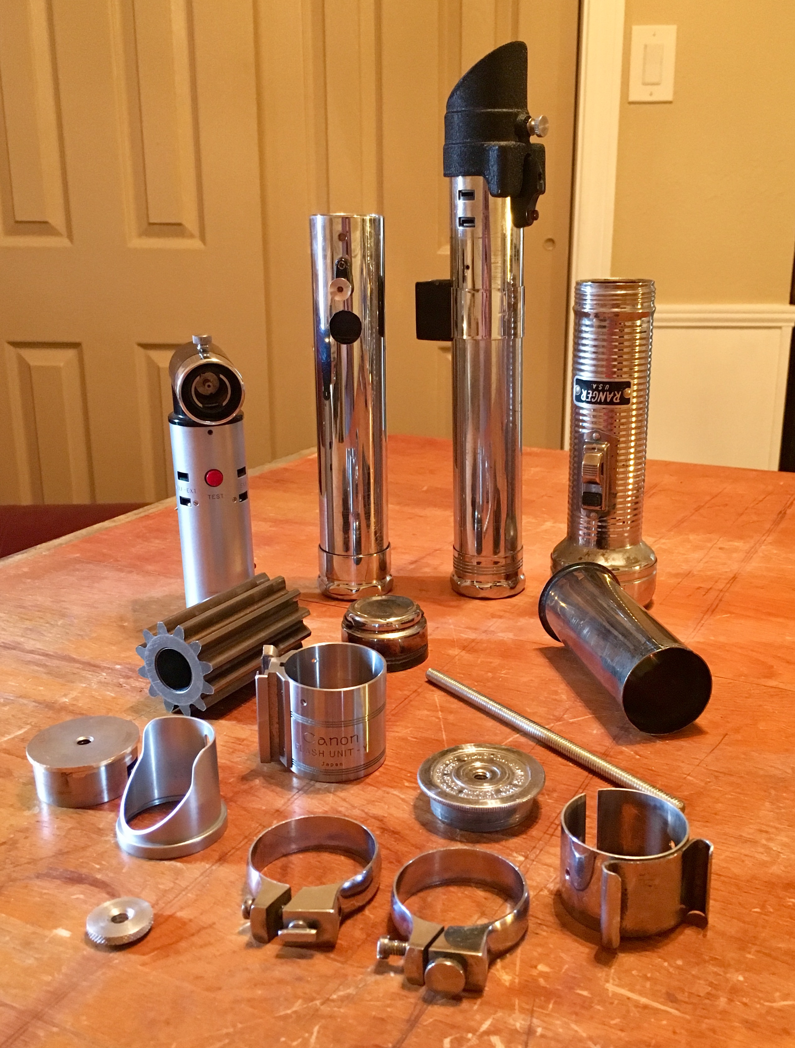 Here are all of the pieces I used that went into it. I used a 1/4 threaded rod, a canon model Y flash, a vintage Ranger flashlight, a vintage industri