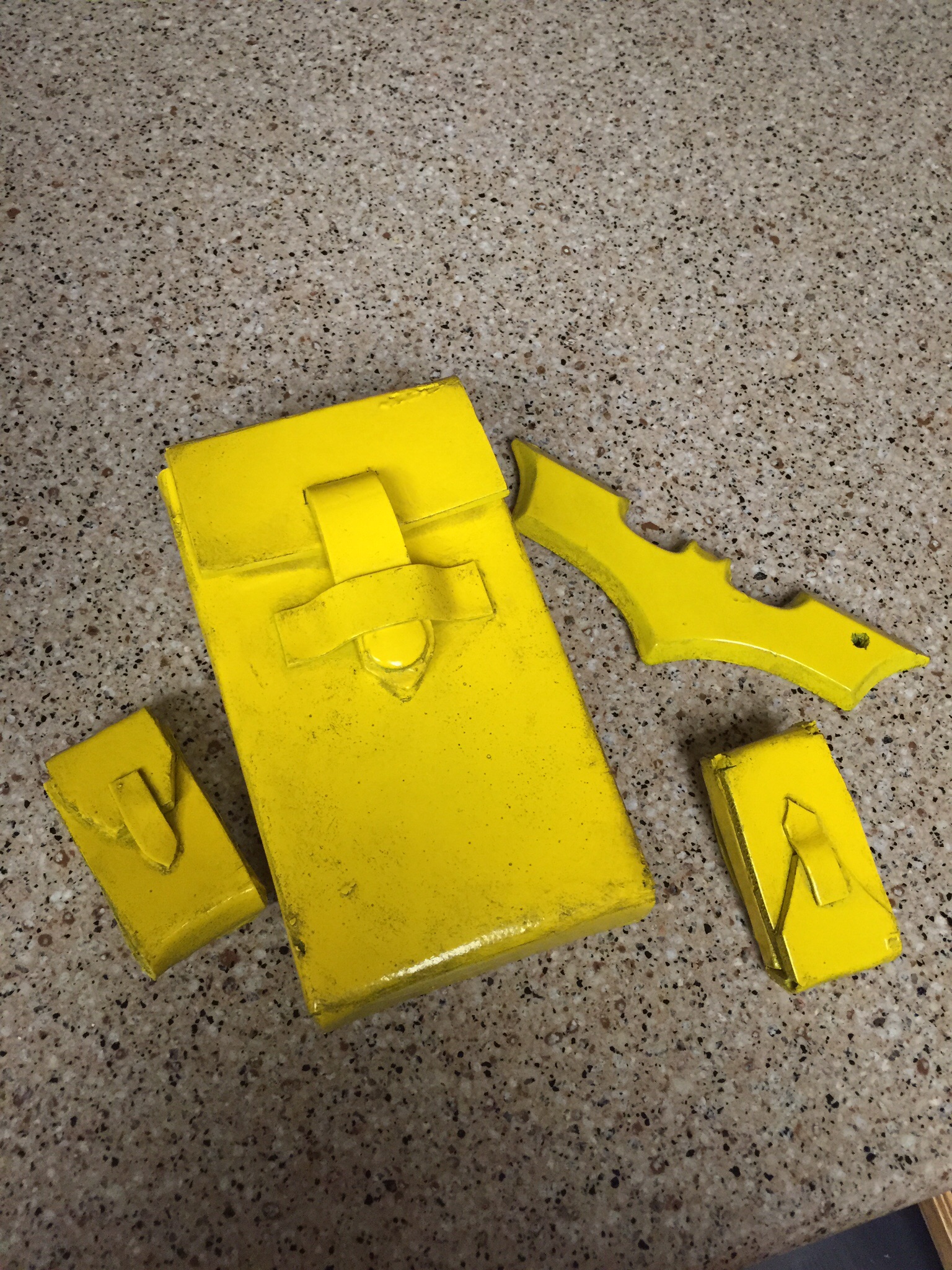 I made my pouches out of foam and hot glue, heat fixed them, plasti-dipped them, and spray painted them.  Then weathered them with a bit of black acry