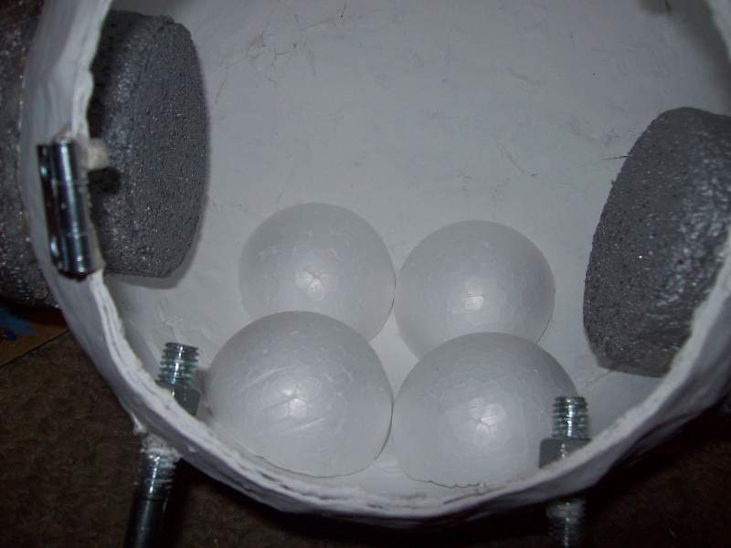 I needed to prop up my alarm clock to match up with the face, so i cut 2 foam spheres in half and glued them in place