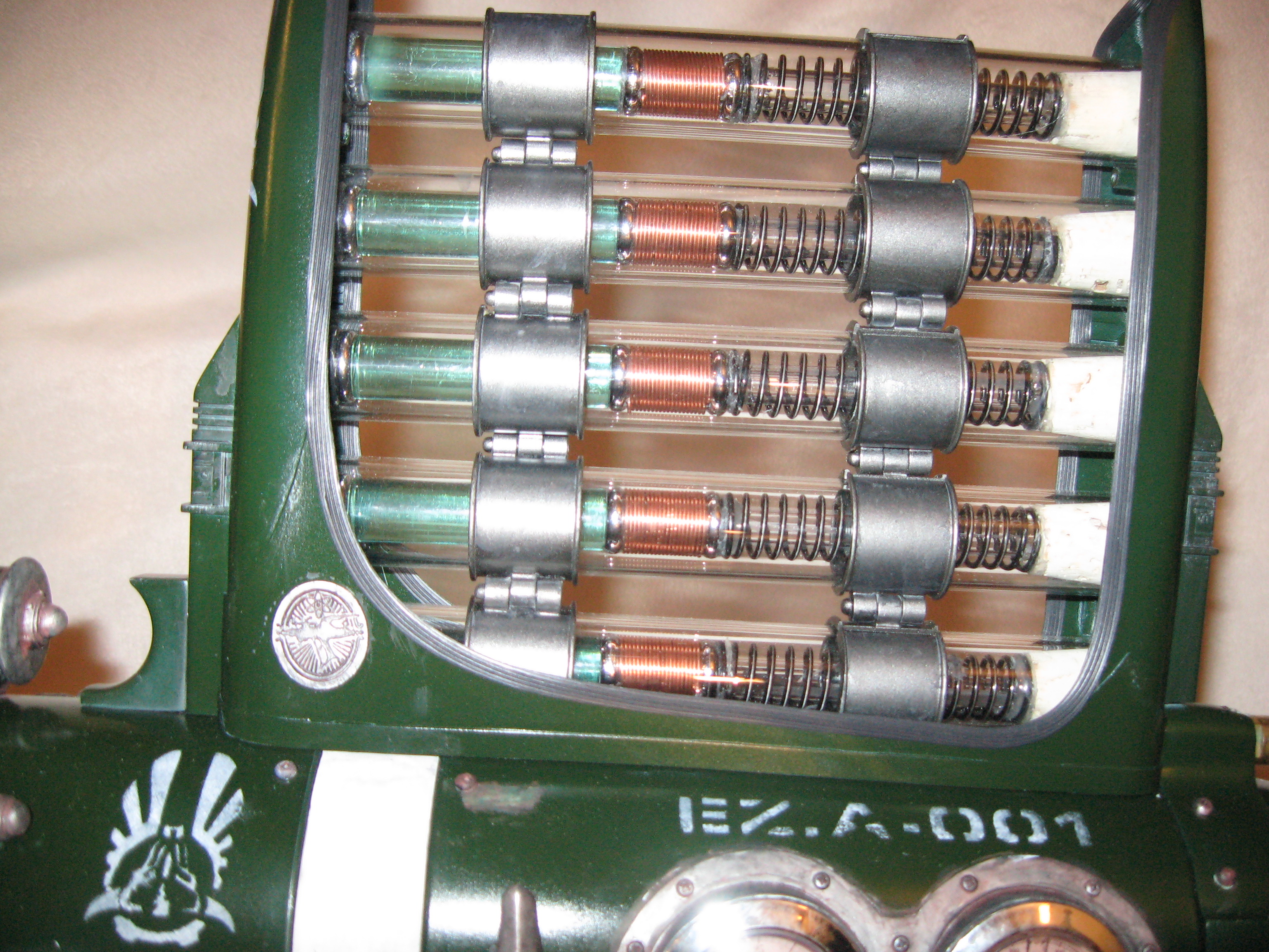 Inside the glass cartridges are green acrylic handles from a strange 70s plastic cutlery set. Then I wrapped pen tubes in copper, and added springs fo