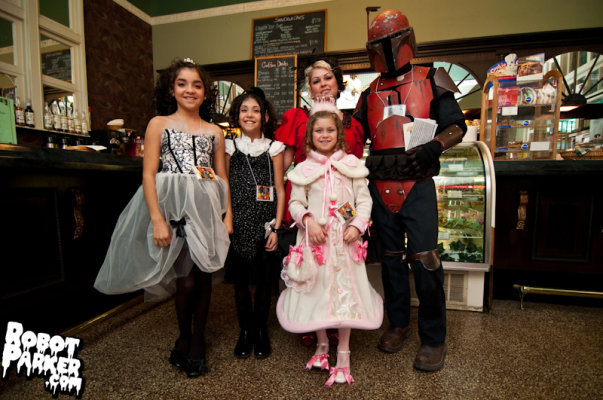 our family at a convention Lolitas and a Mando dresses sewn by me and mandolorian armour made by my husband Chad