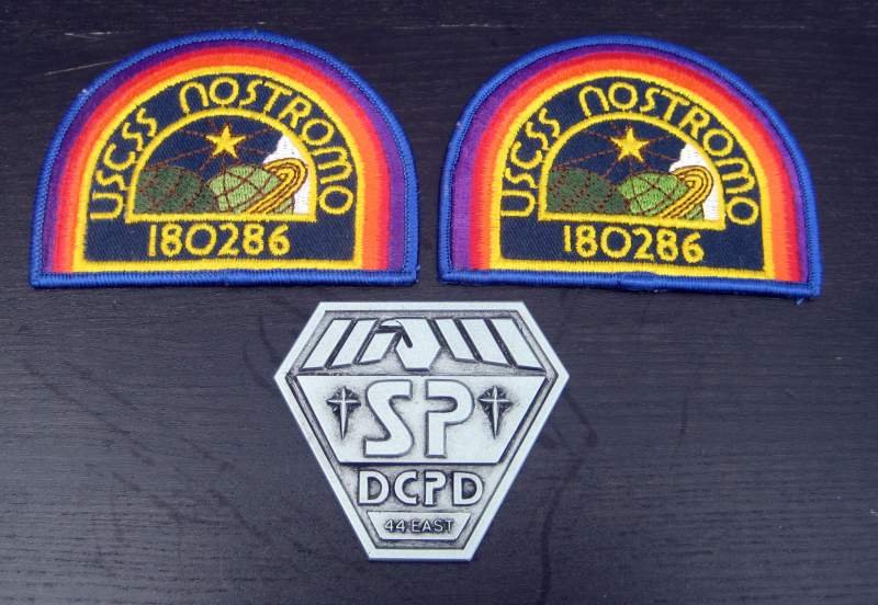 Replica Nostromo badges and original Space Precinct badge