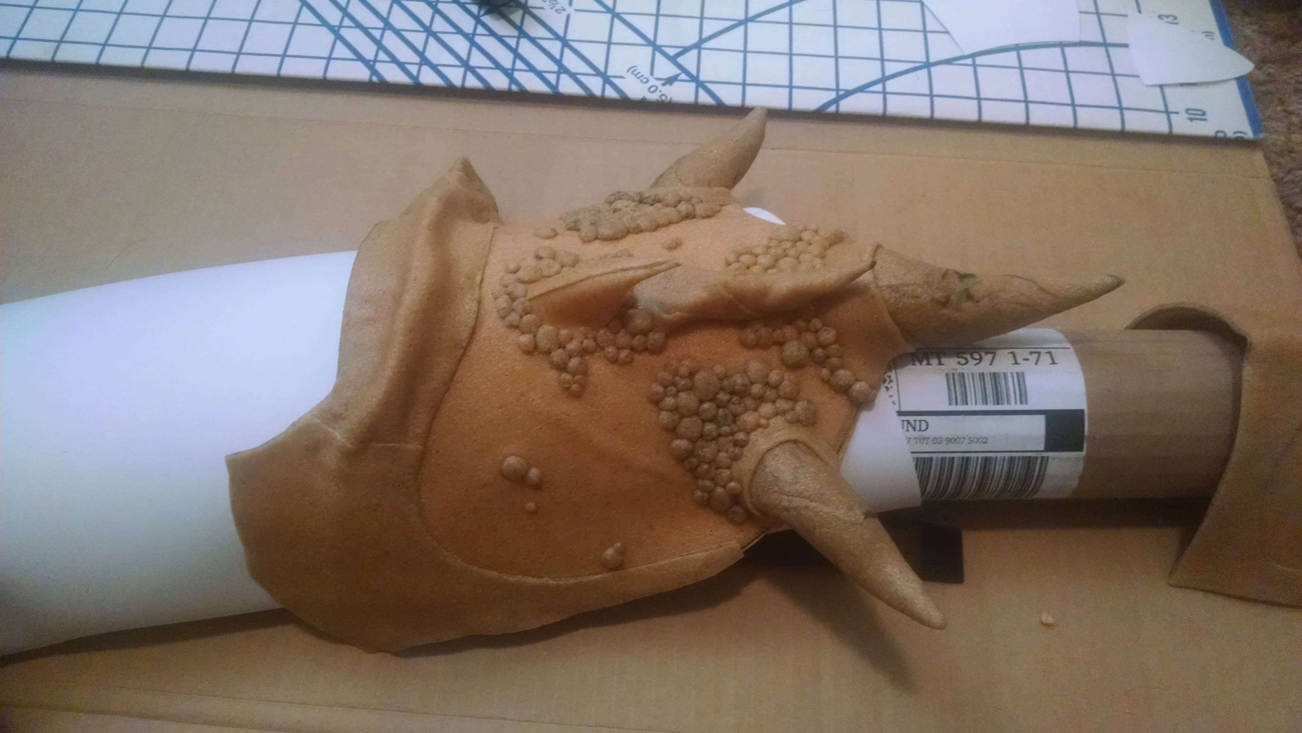 Right pauldron cooling.  A lot of scrap worbla went into these.  I spent a long time heating, rolling, and sticking little worbla peas onto this for t