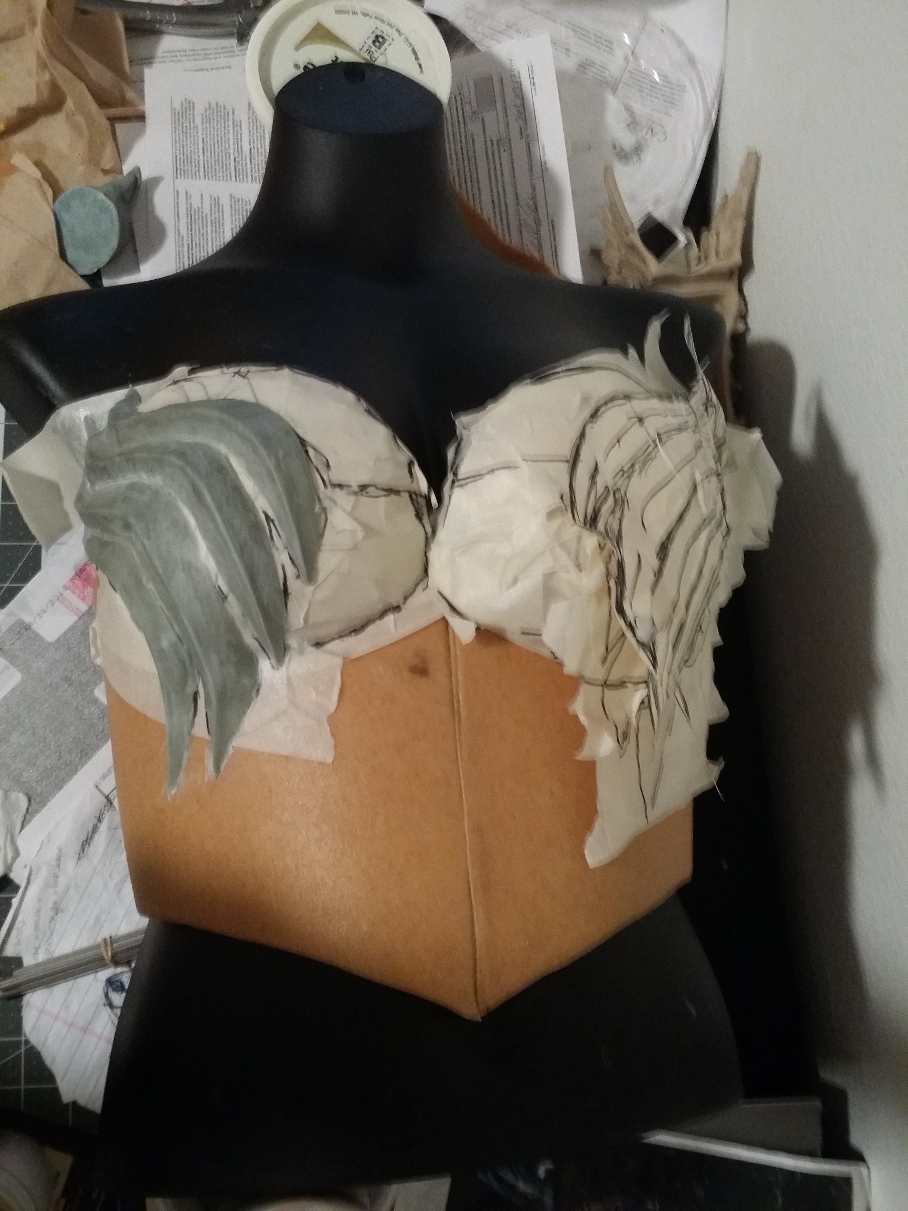 sculpting the wing design on the breastplate