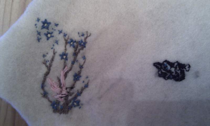 The flowers are my friend's blossom backpiece and the black blob represents a cartoon cat that she is now having removed from her lower back. The doll