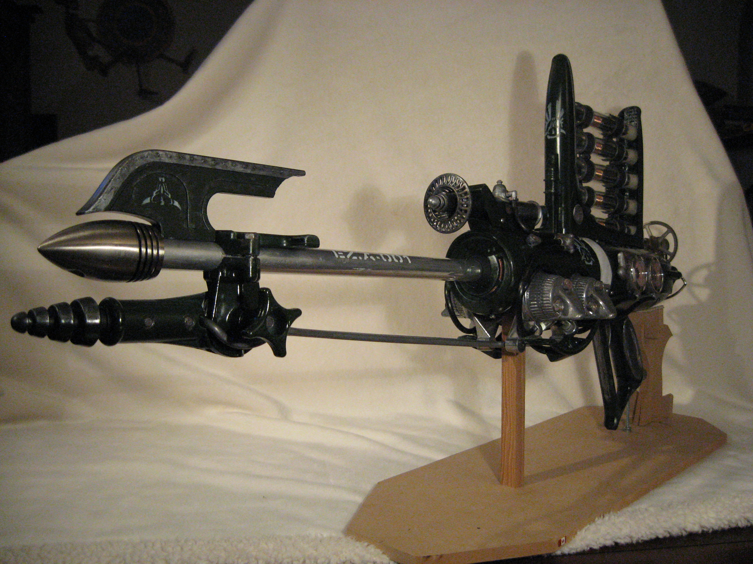 The metal bits, barrel, and strange forward assembly were all from a vintage golf caddie. The polished cone is a light fixture.
