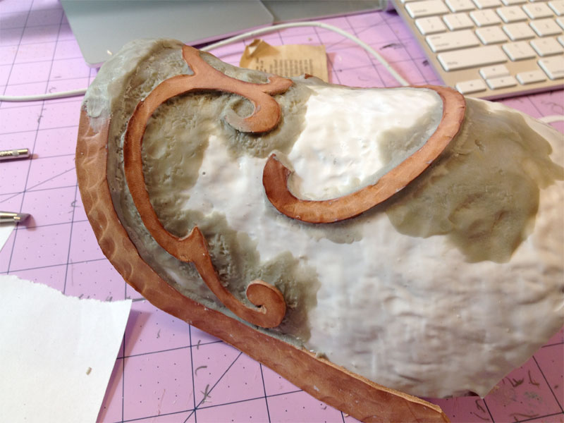 The raised details were made with tooled leather, apoxie sculpt added to the seams.