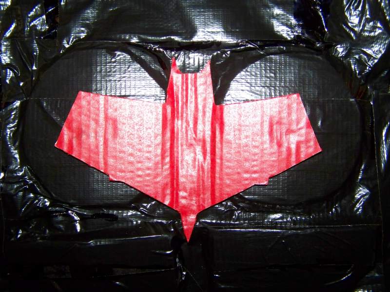 The Red Bat logo on the chest, I didn't realize the pecs were circular till the day after Halloween. The logo is velcro-ed on and can be swapped with